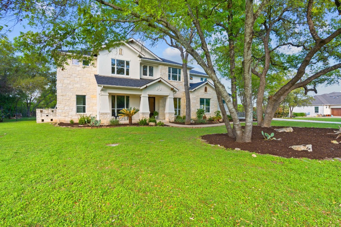 a front view of house with yard and green space