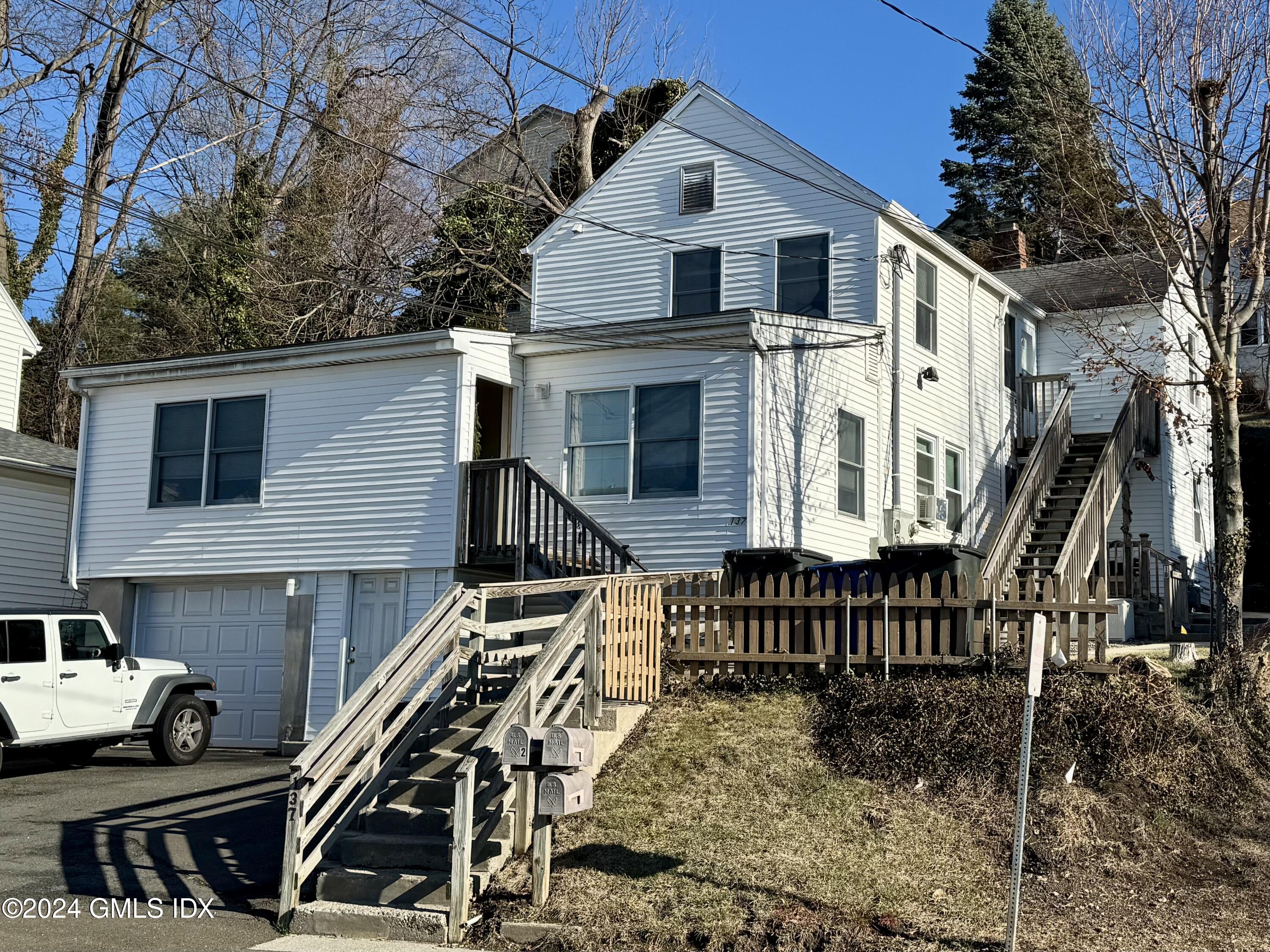 a front view of a house with stairs