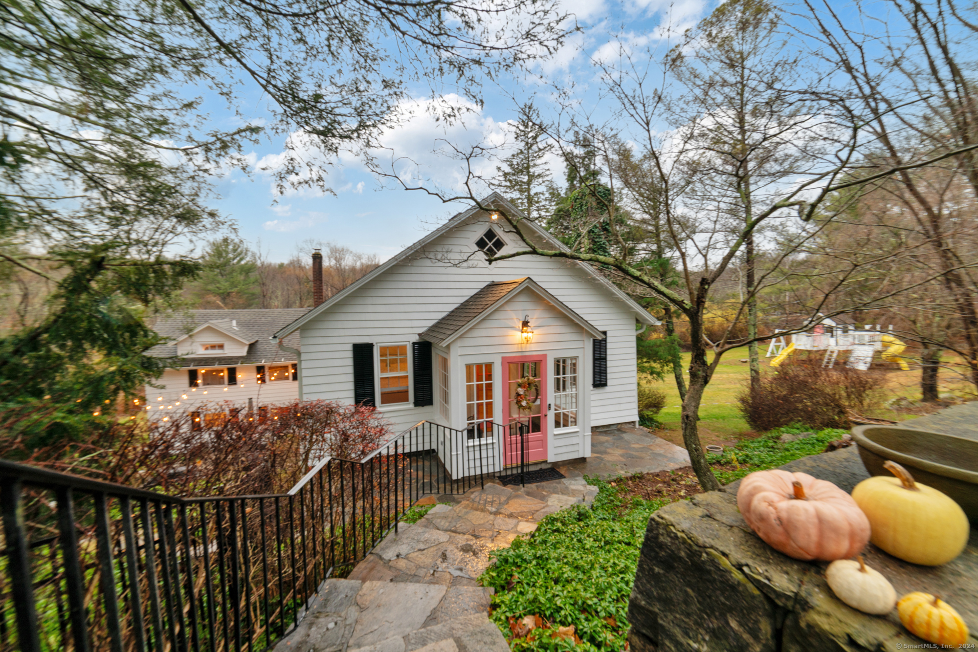 a view of a house with a wooden fence