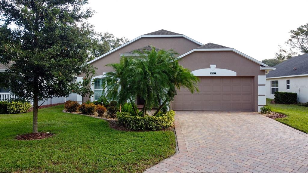 a front view of a house with a yard and garage