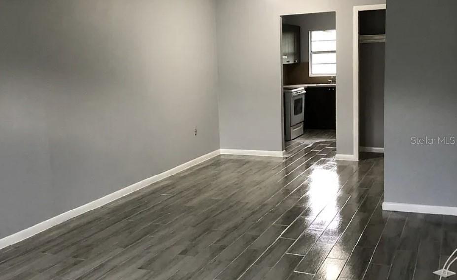 a view of hallway with wooden floor