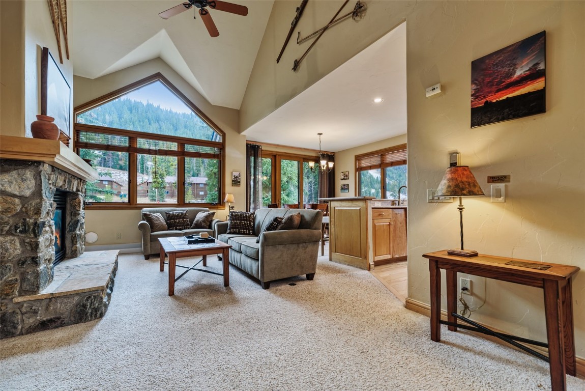 Living room featuring a stone fireplace.