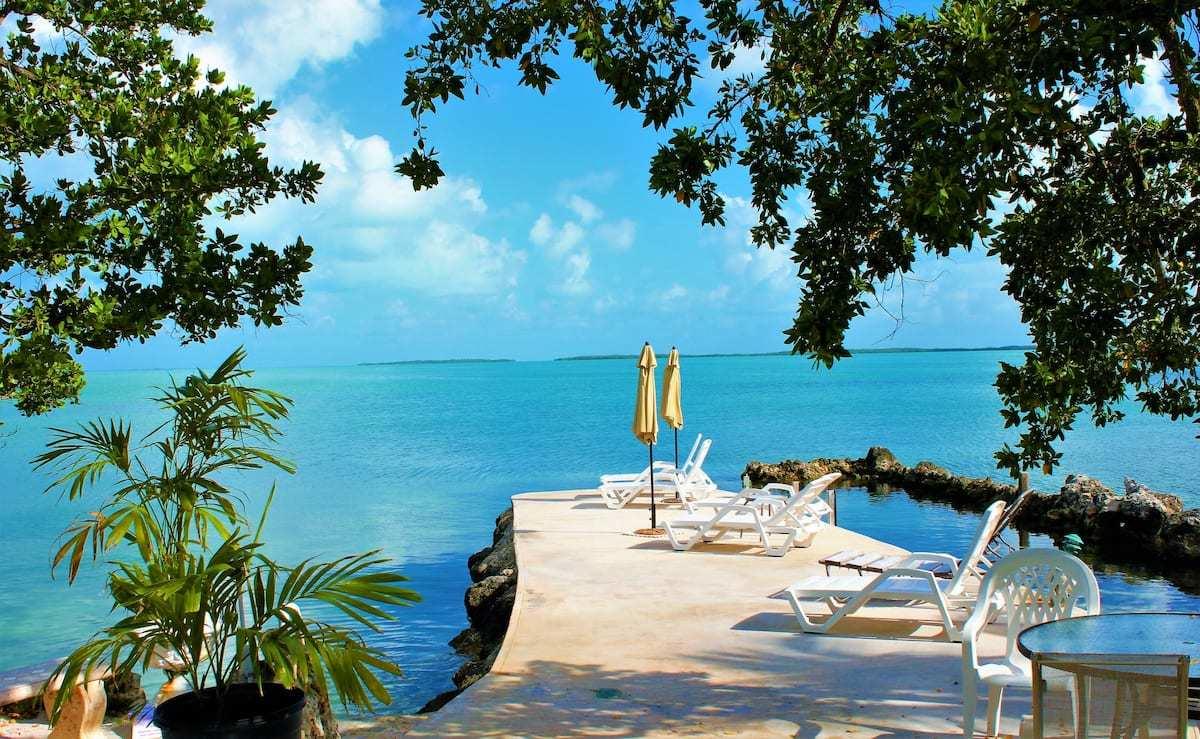 a view of a lake with a table and chairs