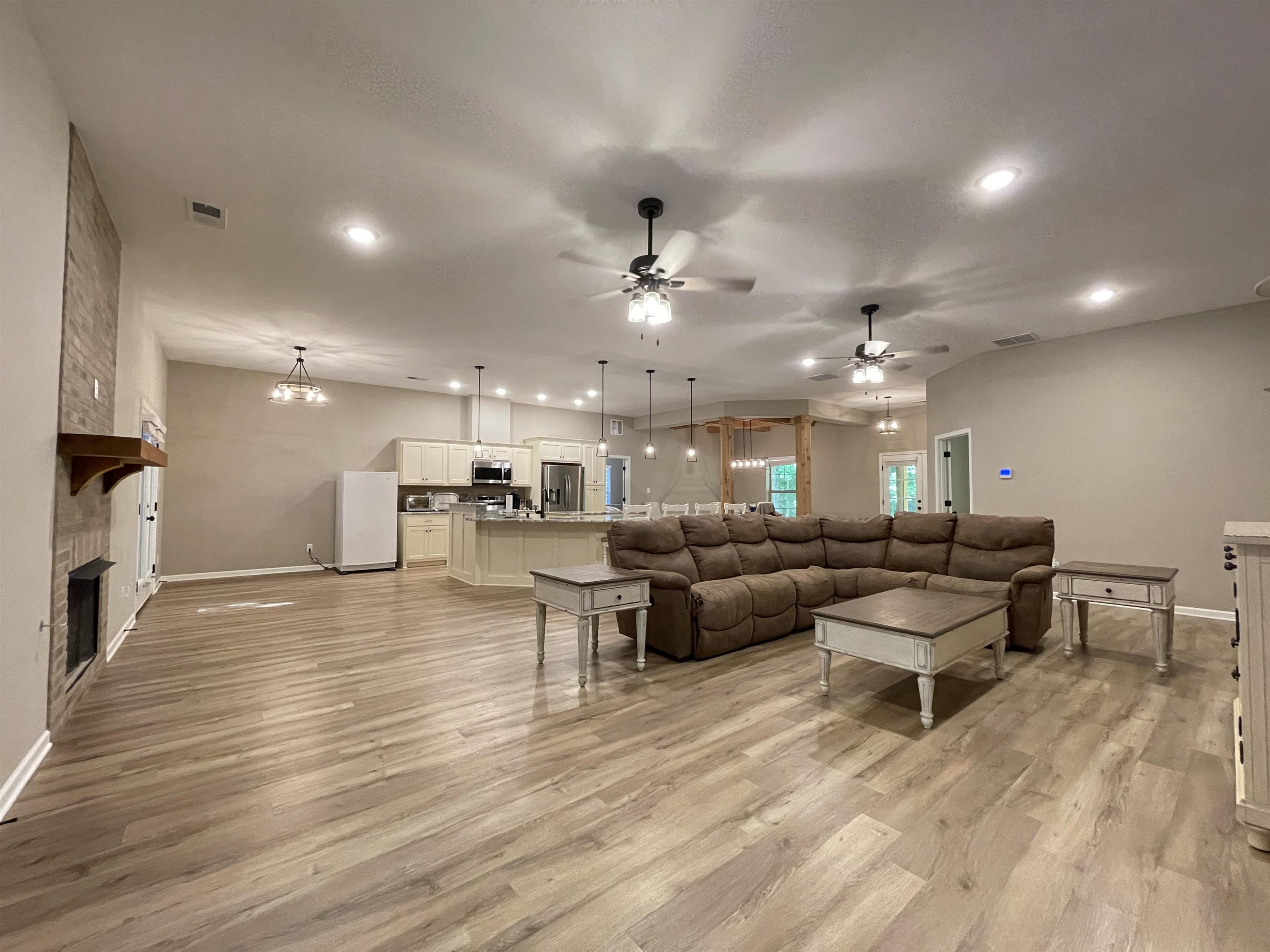 a living room with lots of furniture and kitchen view