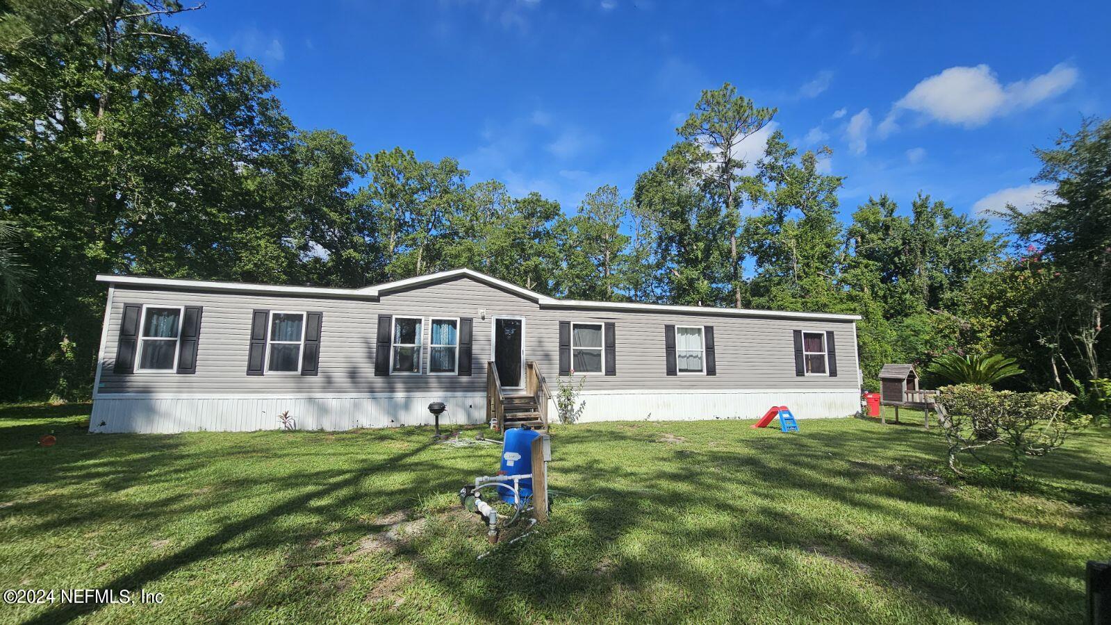 a front view of house with yard and green space