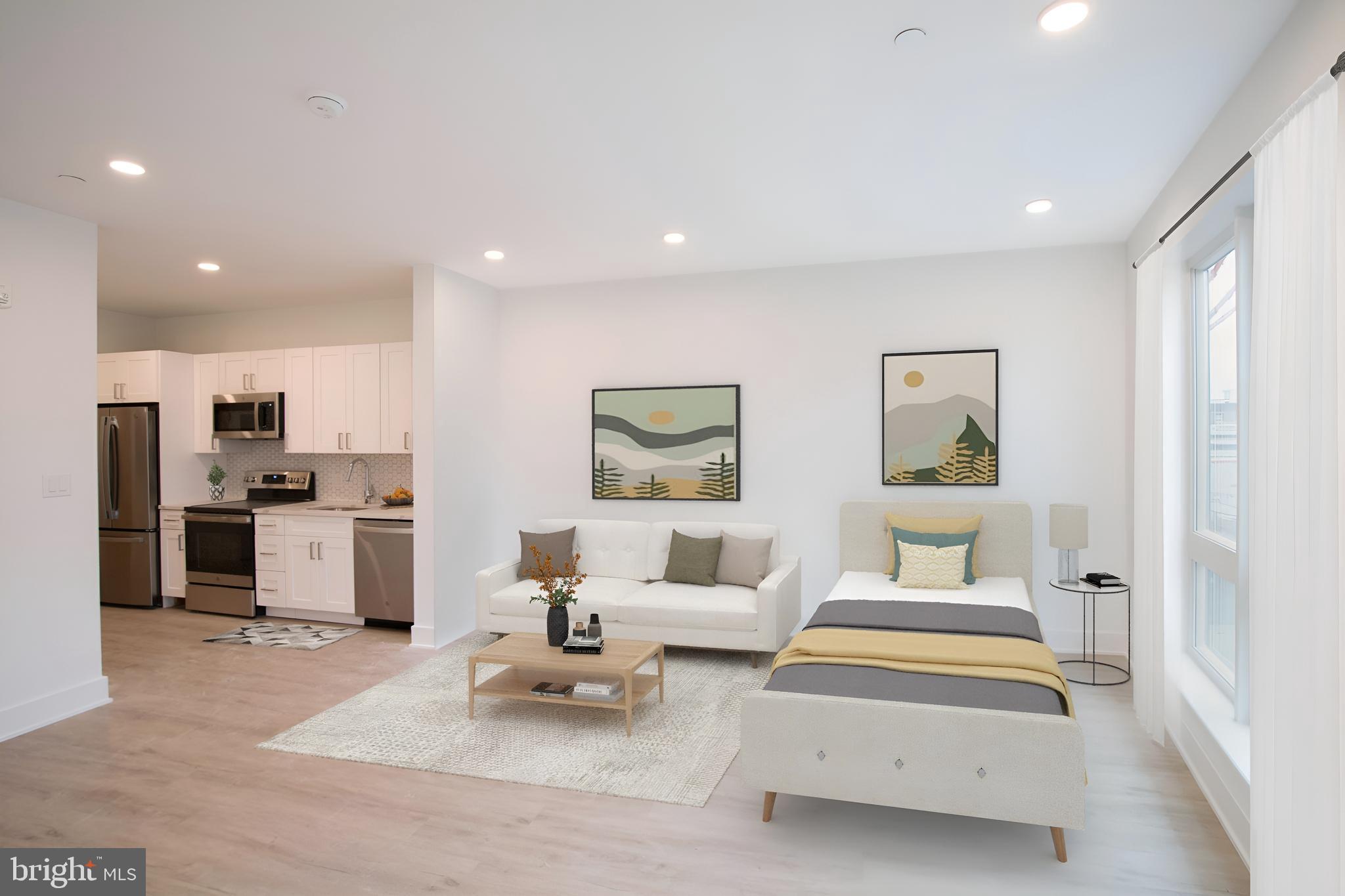 a living room with furniture and kitchen view