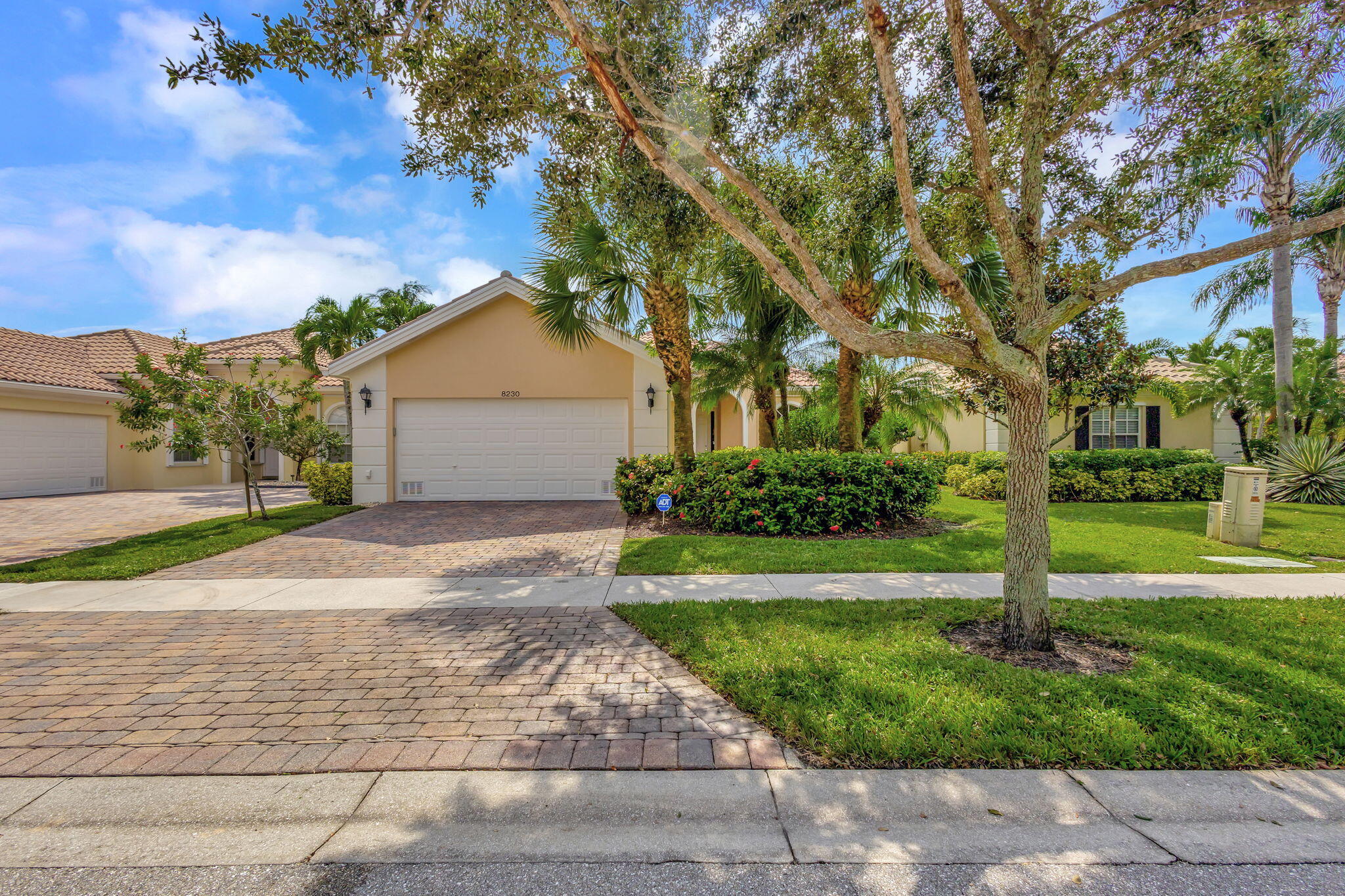 a front view of a house with a yard and trees