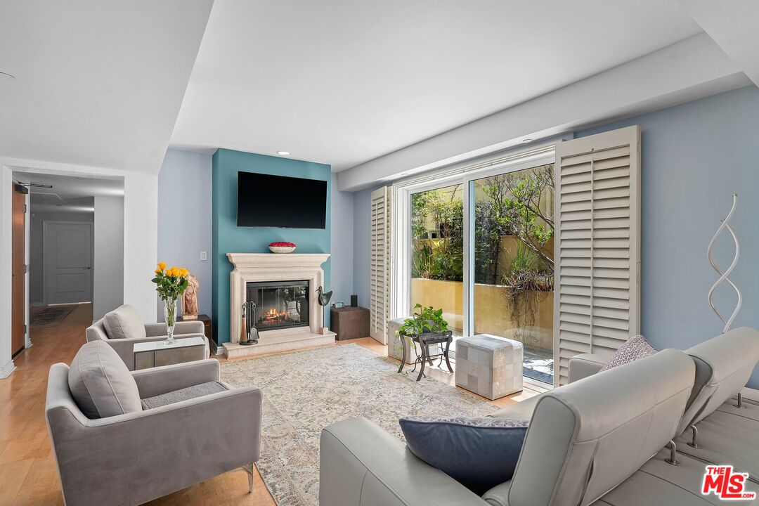 a living room with furniture a fireplace and a flat screen tv