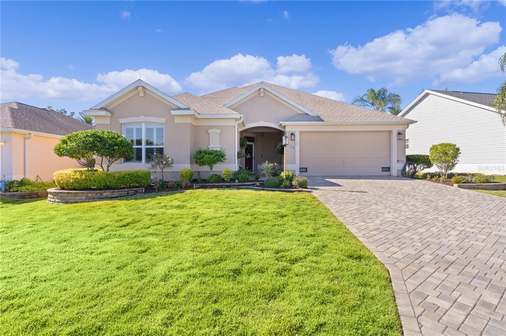 a front view of house with yard and trees