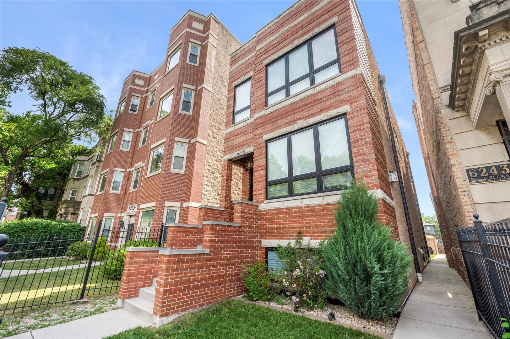 a view of a brick building next to a yard