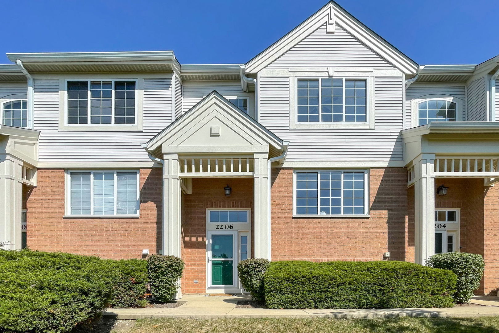 a front view of a house with a yard