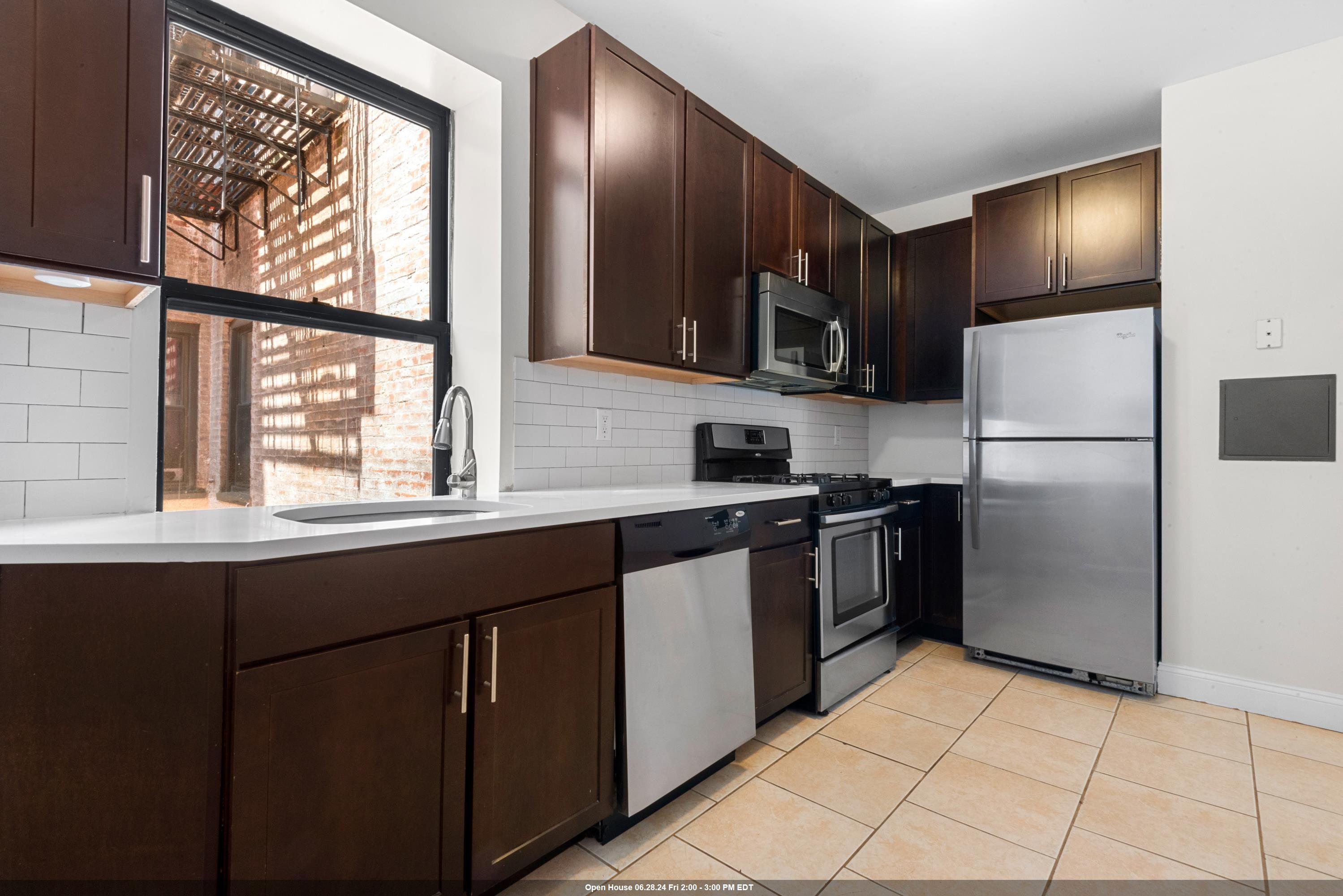 a kitchen with stainless steel appliances a refrigerator and a sink