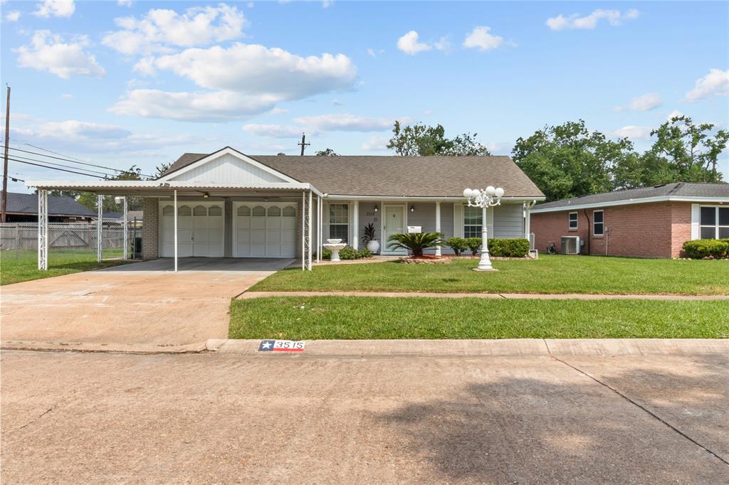 a front view of a house with a garden and trees