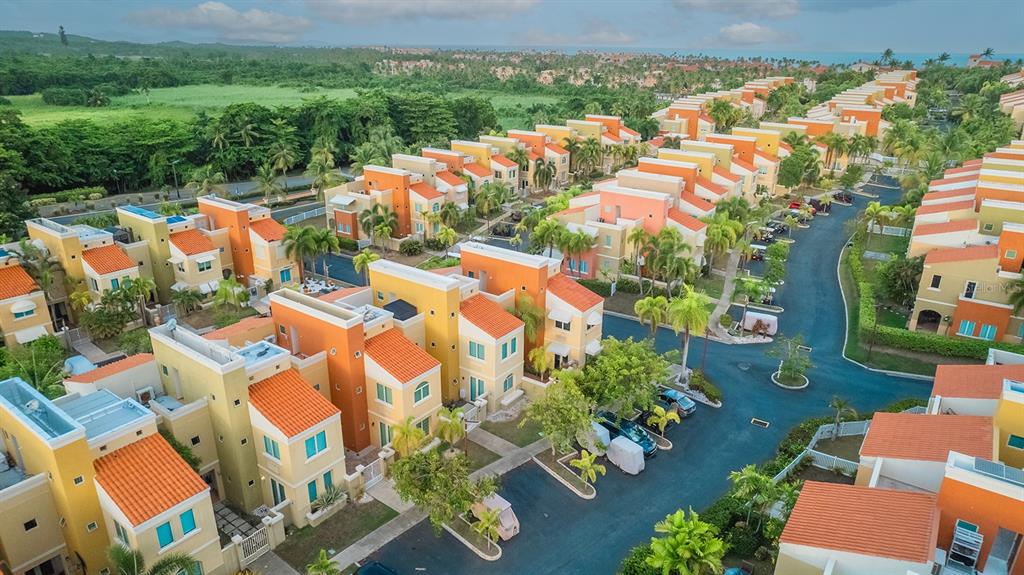 an aerial view of residential houses with outdoor space and street view