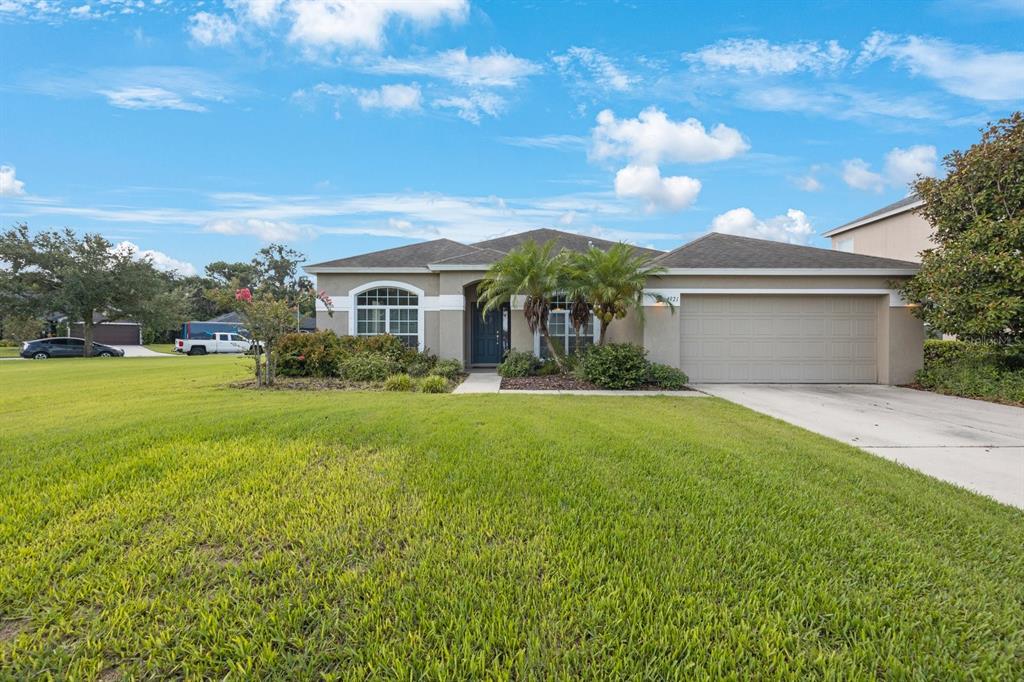 a front view of house with yard and green space