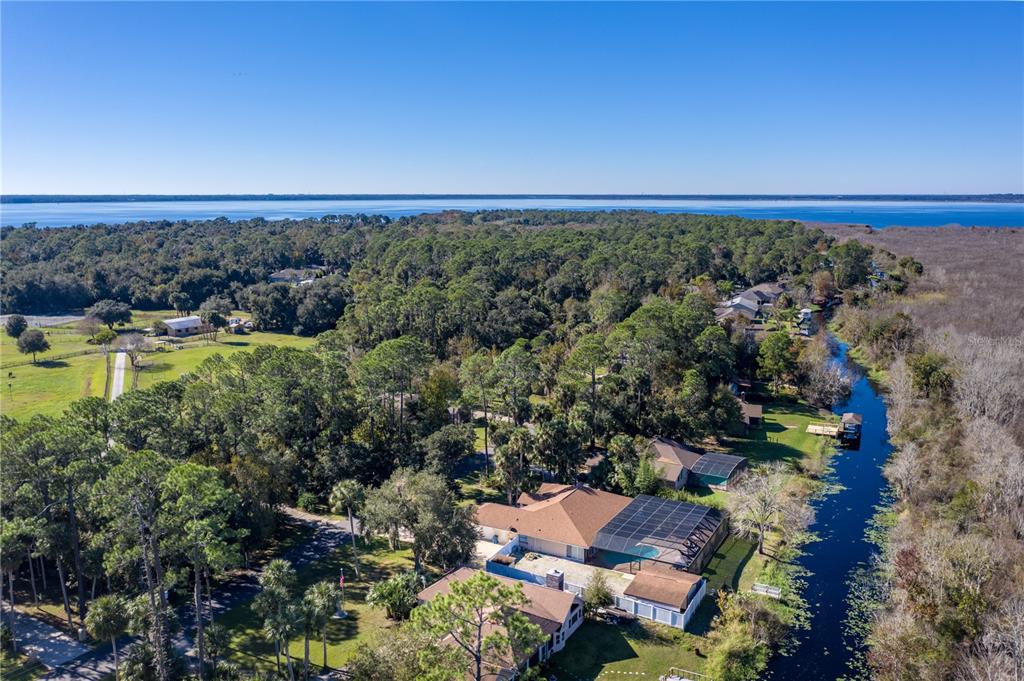 an aerial view of a houses with outdoor space and trees