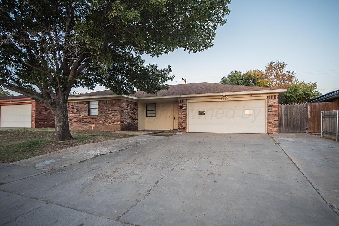 a view of a house with a yard and garage