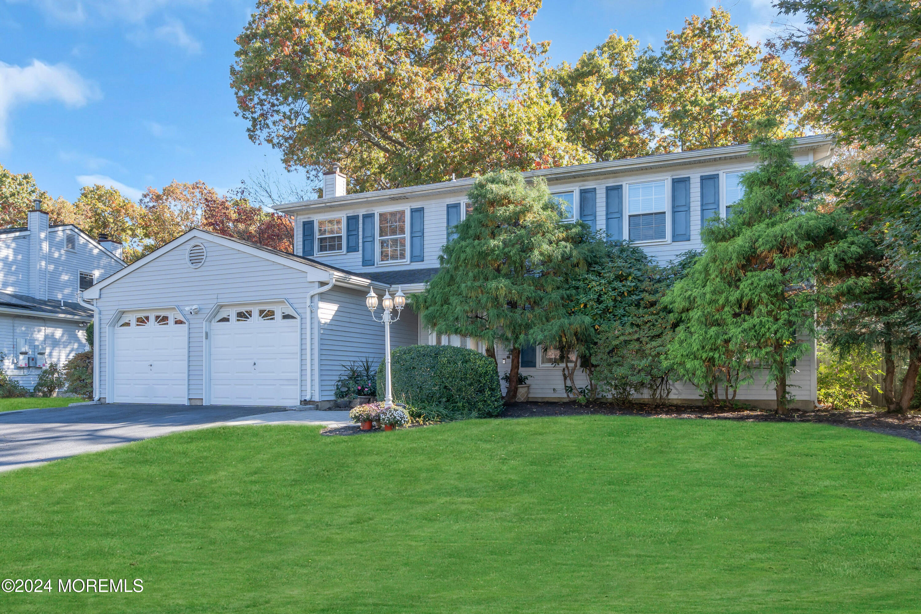 a front view of house with yard and green space