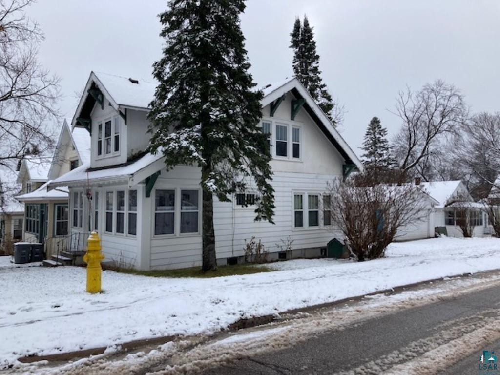 Snow covered property featuring central air condition unit