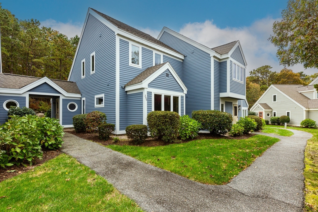 a front view of house with yard and green space