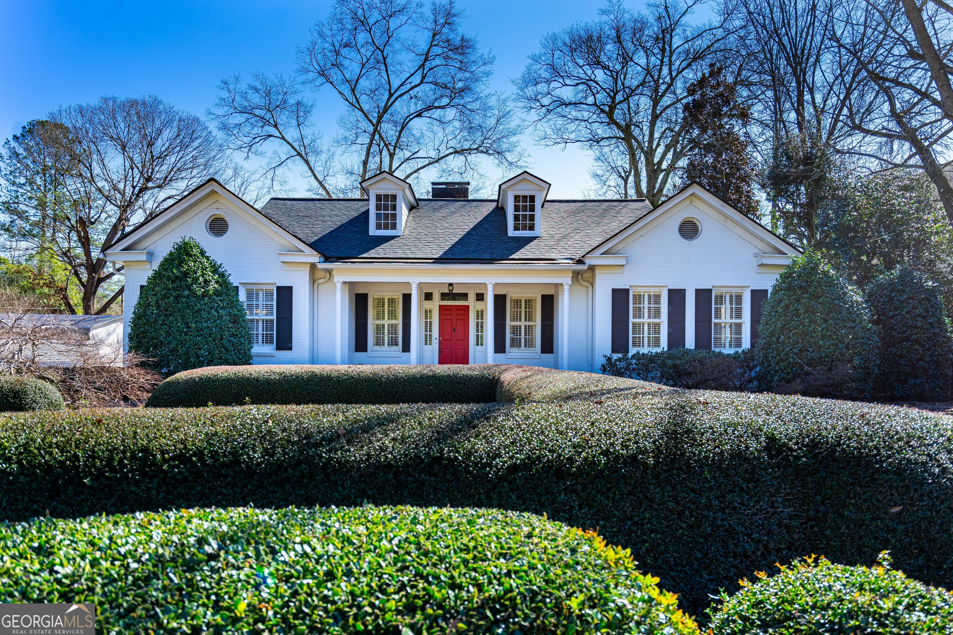 a front view of a house with a garden