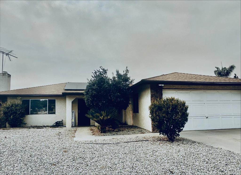 a view of a house with a yard and garage