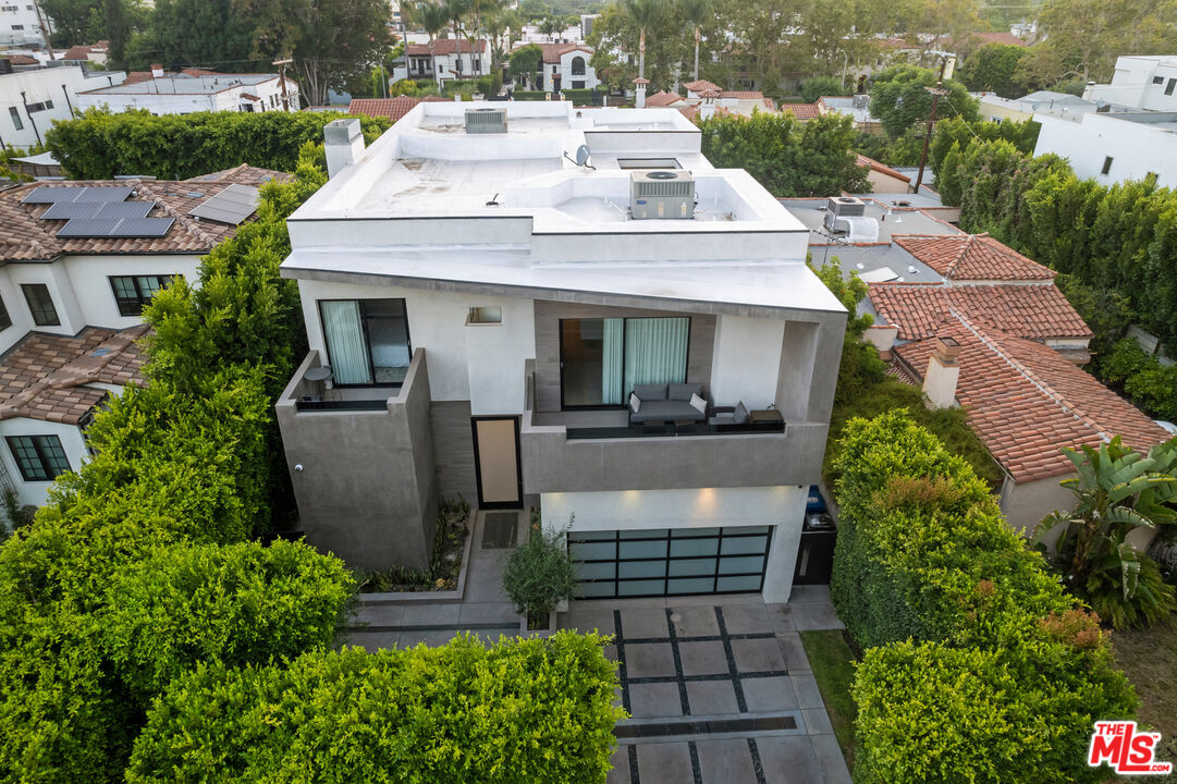 an aerial view of a house with a yard and potted plants