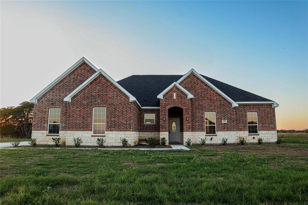 a front view of house with yard and green space