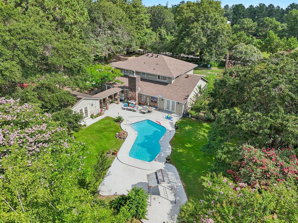 an aerial view of a house with garden space ocean and mountain view