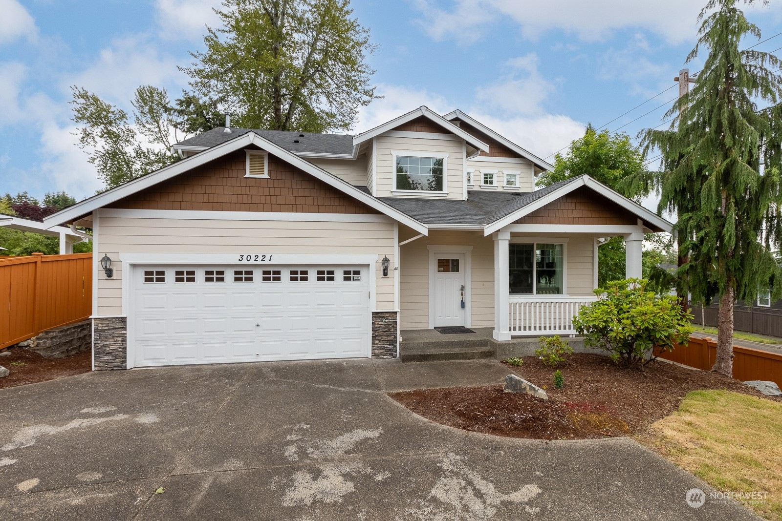 a view of a house with a yard and garage