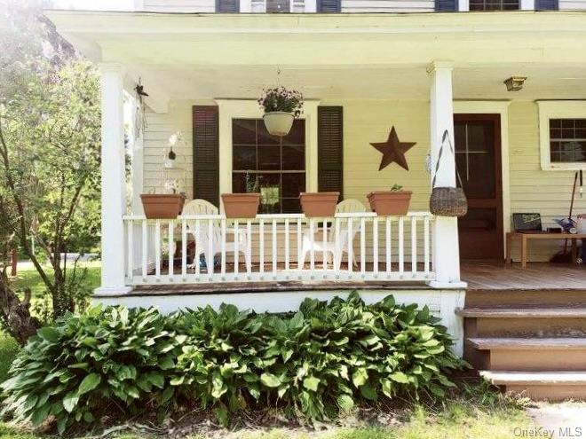 a view of a house with a small yard and wooden fence