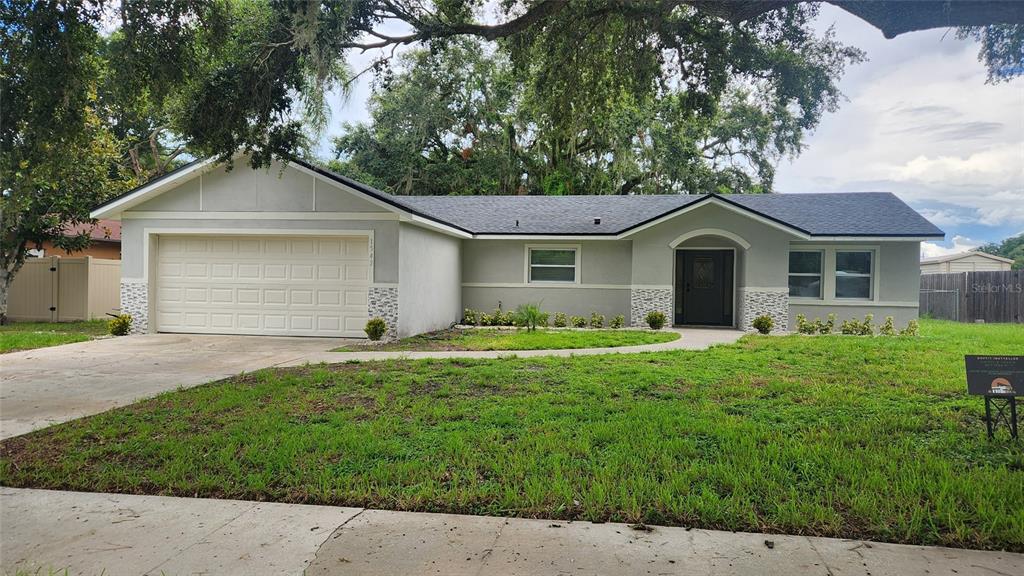 a front view of a house with a yard and garage