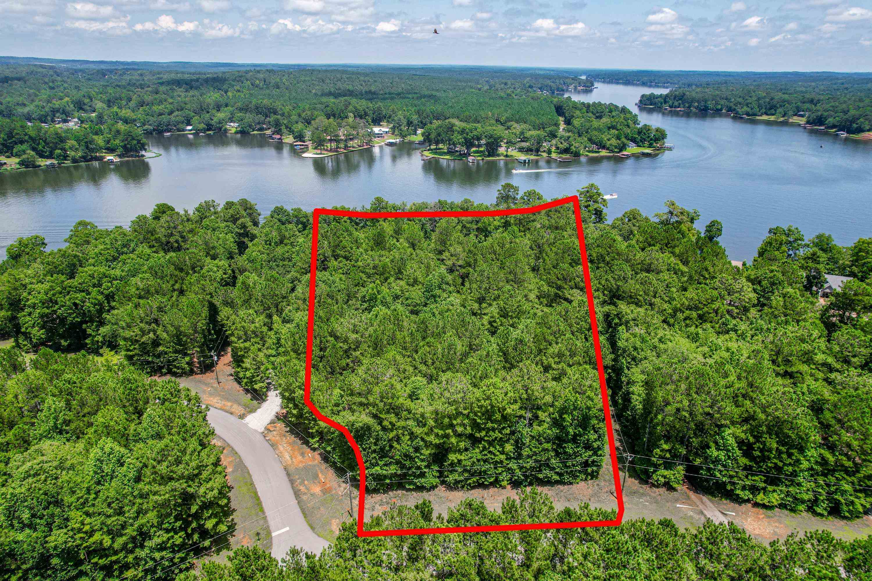 an aerial view of a house with a yard and lake view