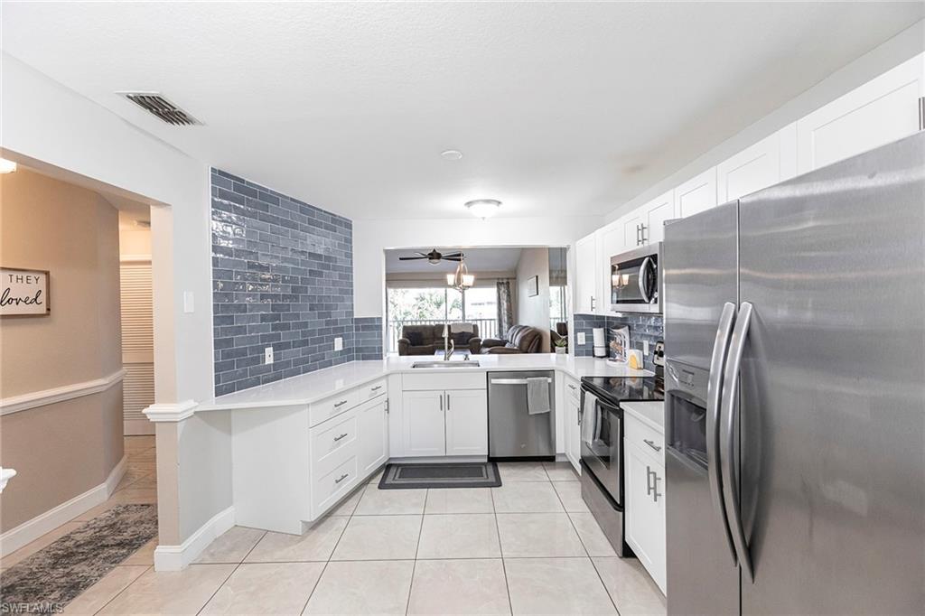 a kitchen with cabinets and stainless steel appliances