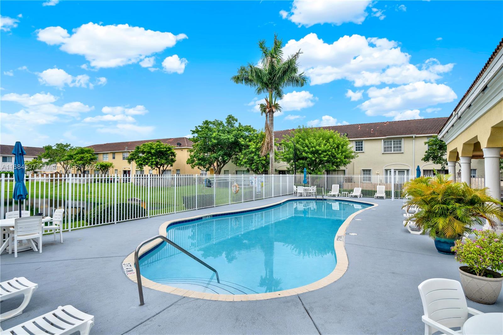 a swimming pool with outdoor seating and yard