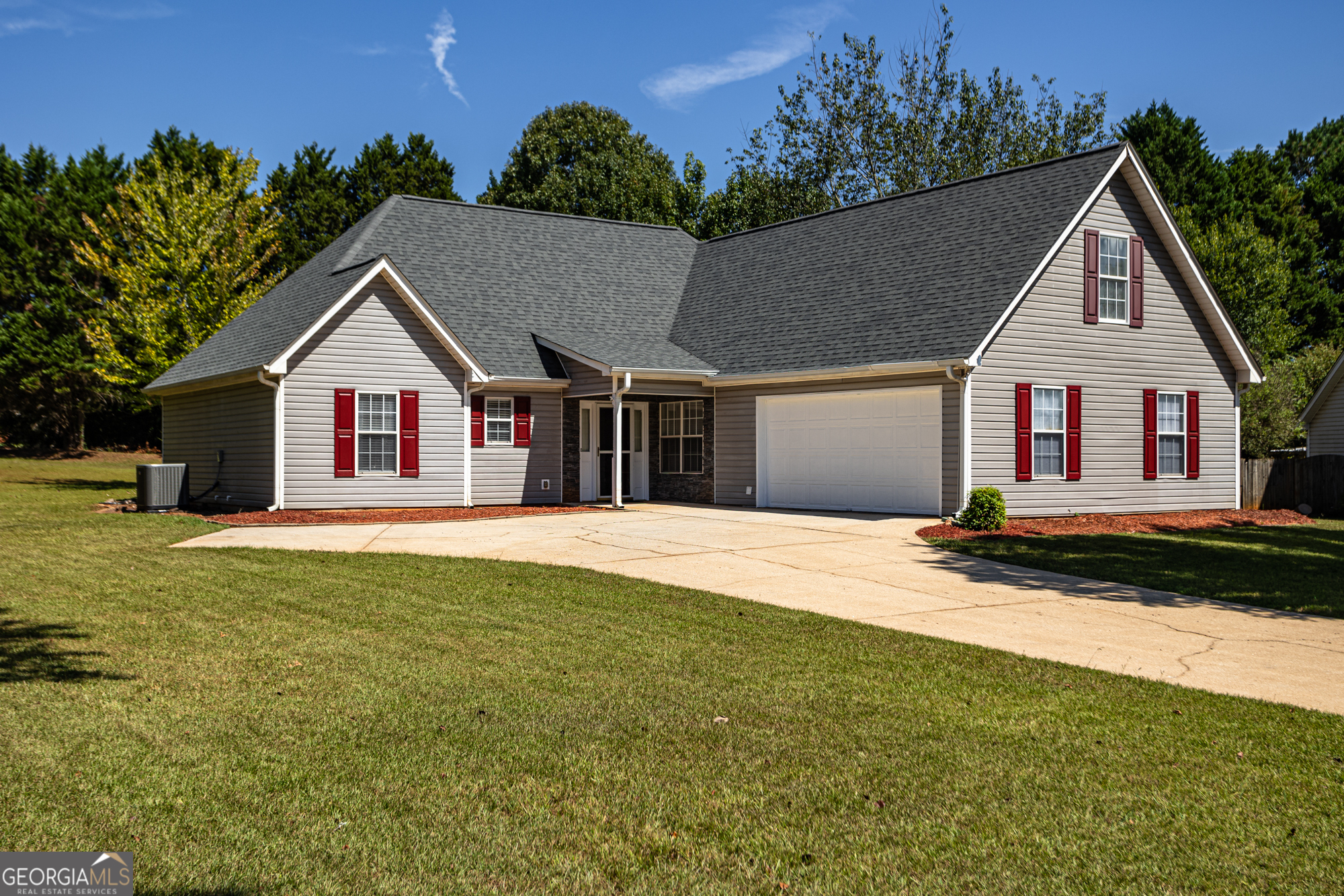 a view of a house with a yard and tree s