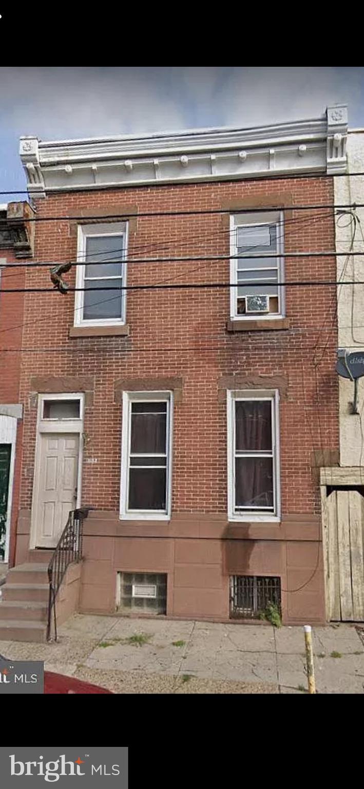 a view of a brick building with many windows