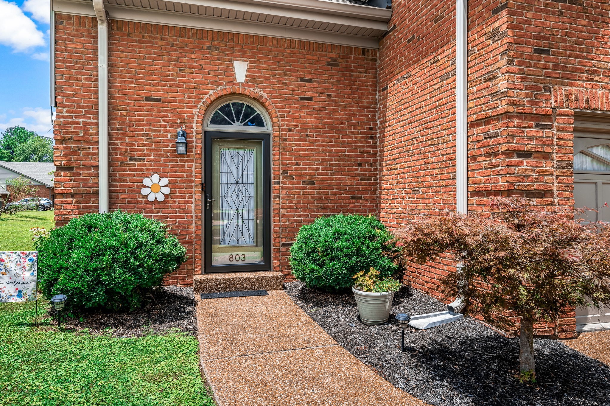 a front view of a house with garden