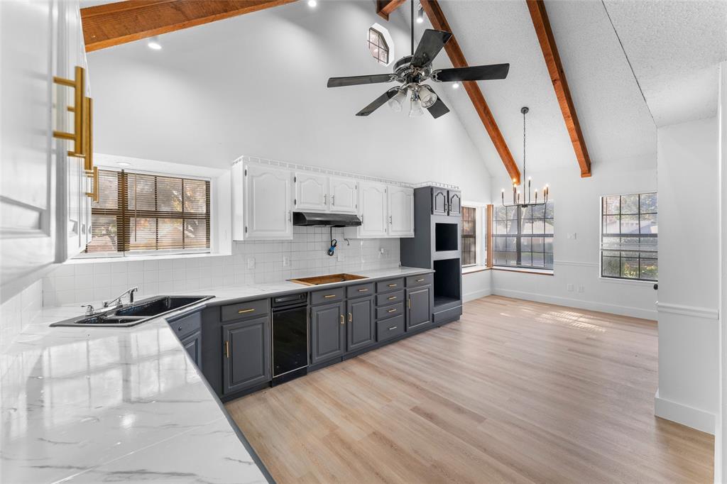 a open kitchen with stainless steel appliances granite countertop a refrigerator and a sink