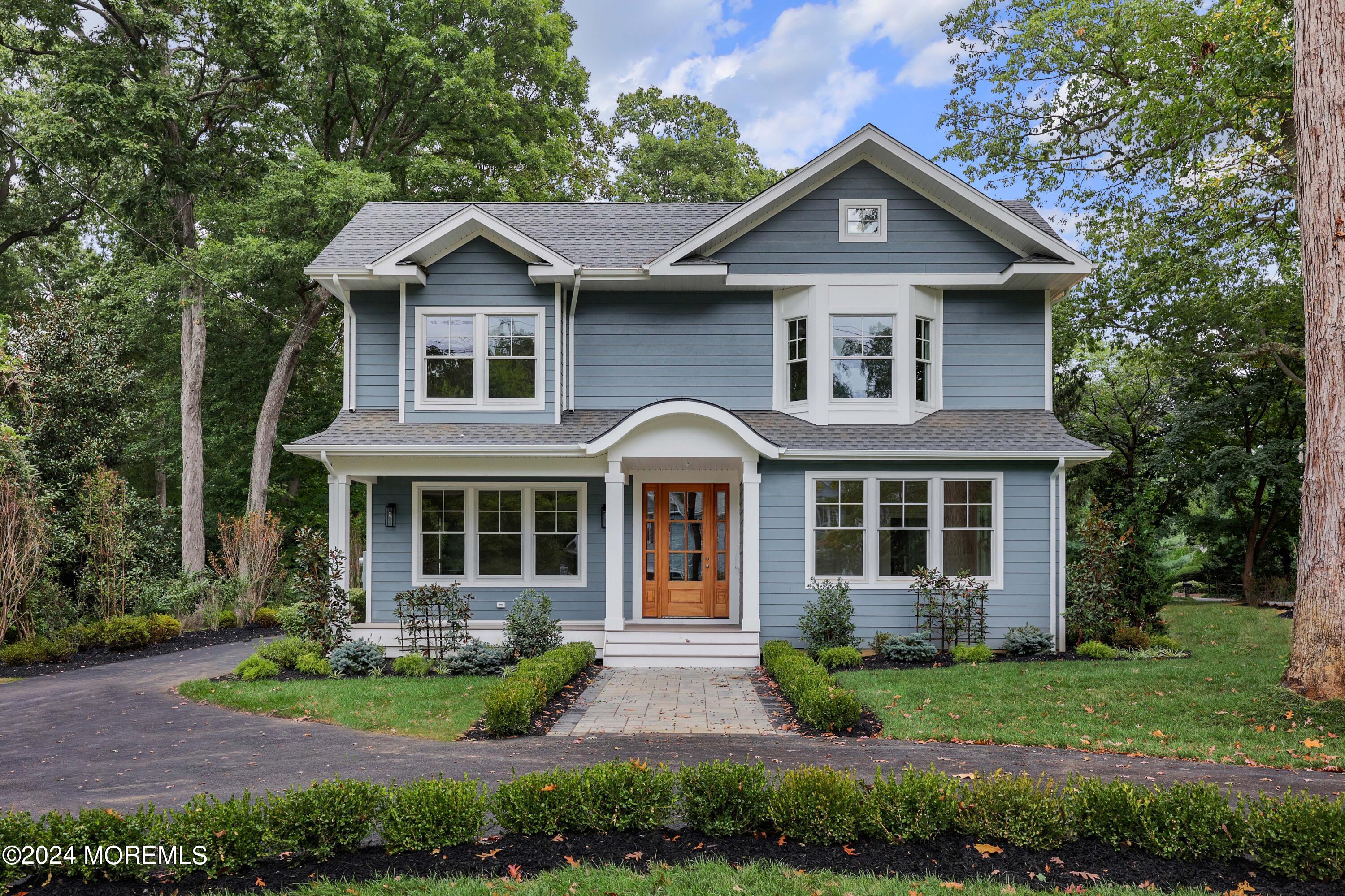 a front view of a house with garden and porch