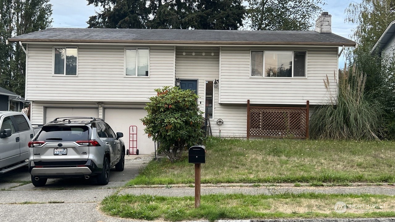 a view of a white house and a yard in front of a house