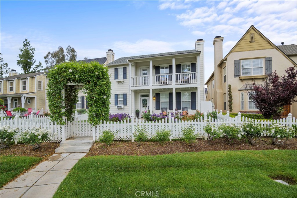 a front view of a house with a garden and plants