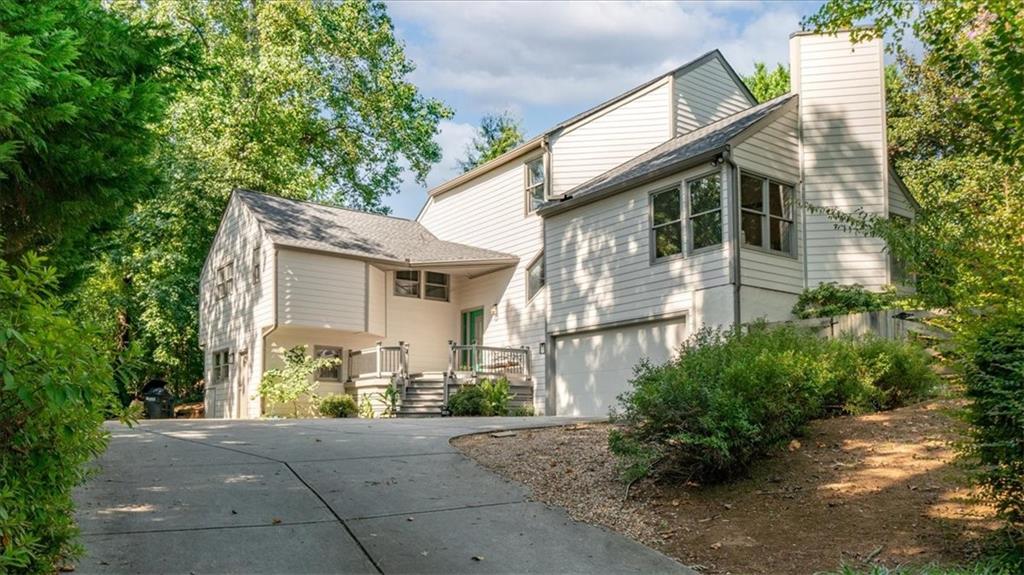 a front view of a house with a yard and a garage