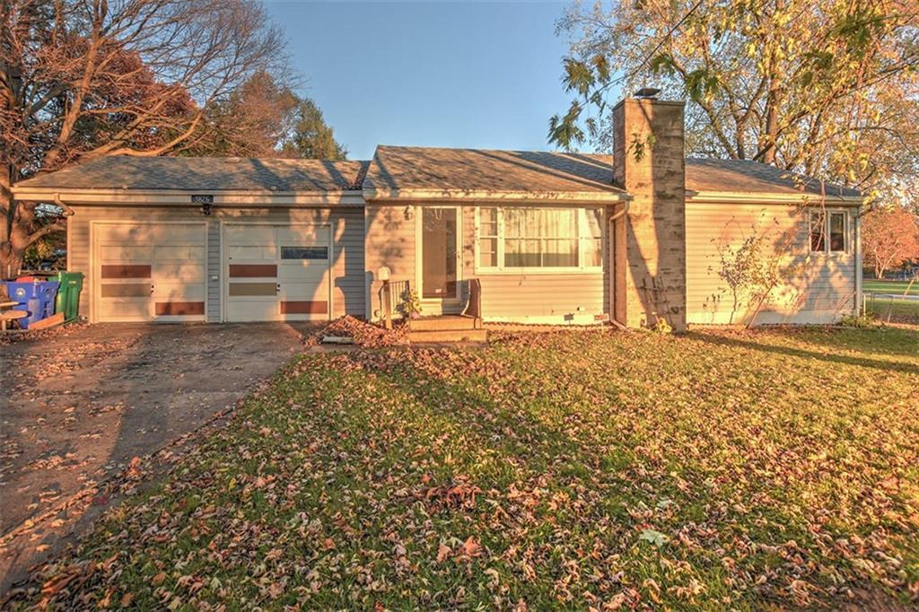 a view of a house with a large window and a yard