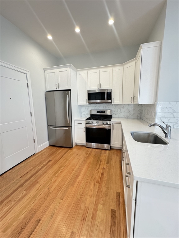 a kitchen with wooden cabinets and stainless steel appliances