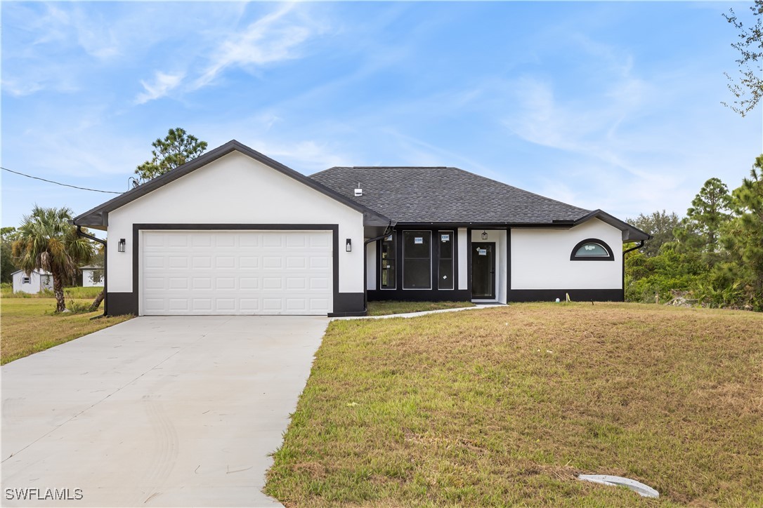 a front view of a house with a yard and garage