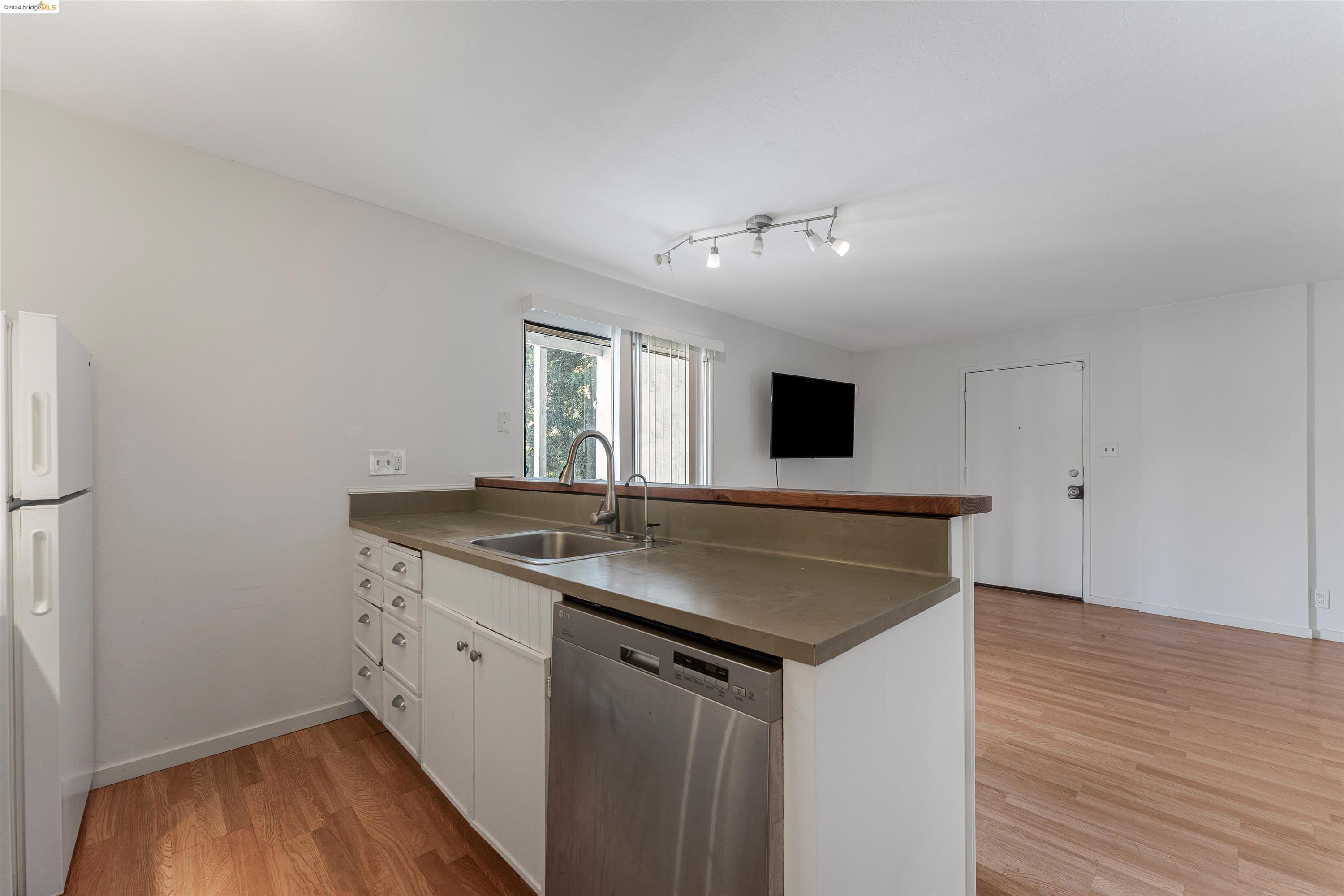 a kitchen with a sink and a refrigerator