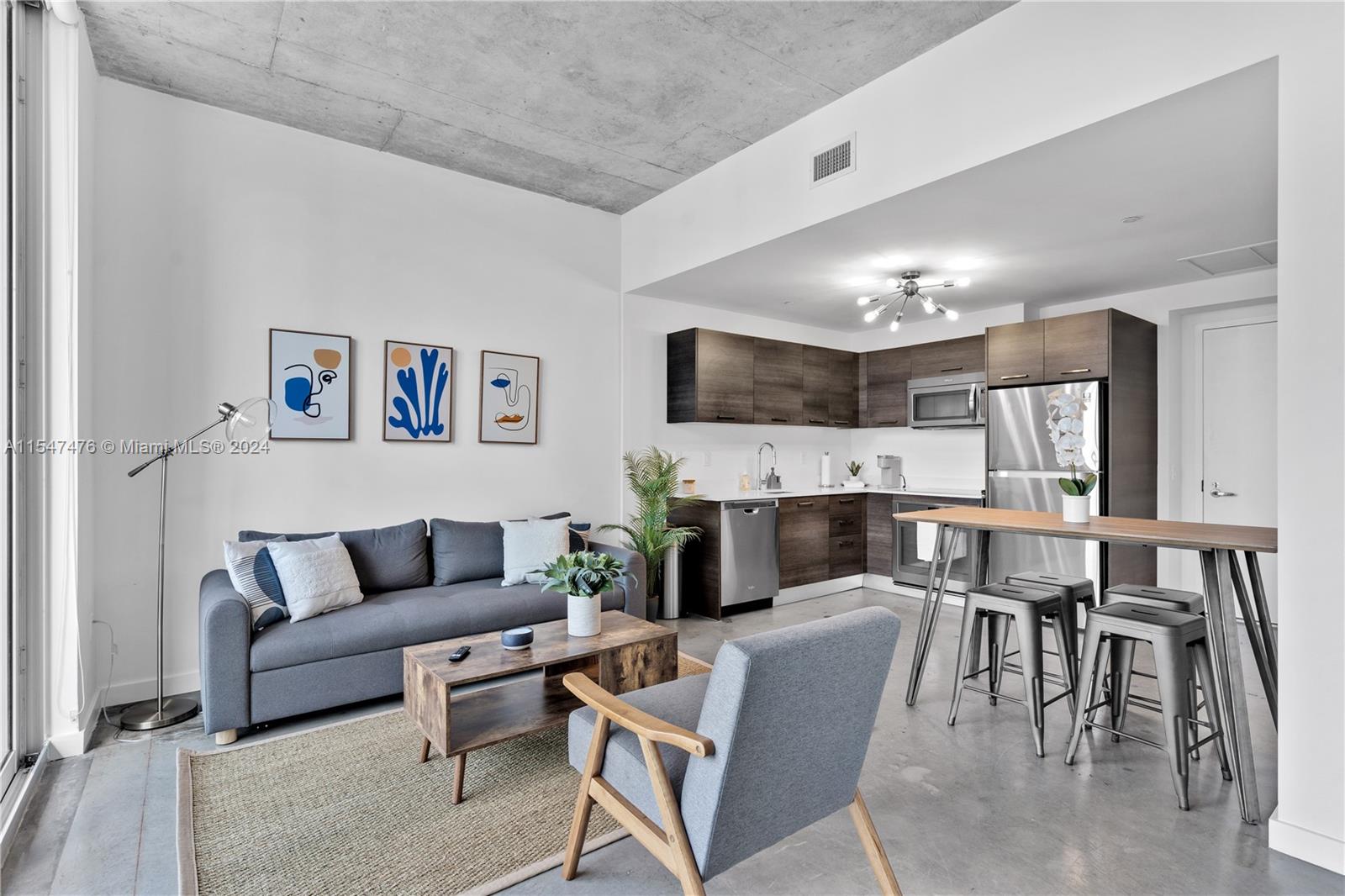 a living room with furniture a dining table and a fireplace