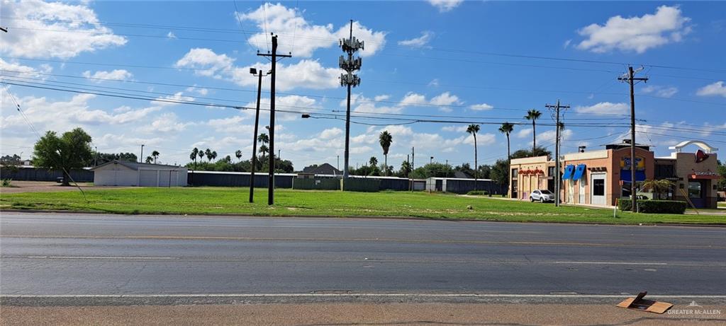 a view of a road with a big house