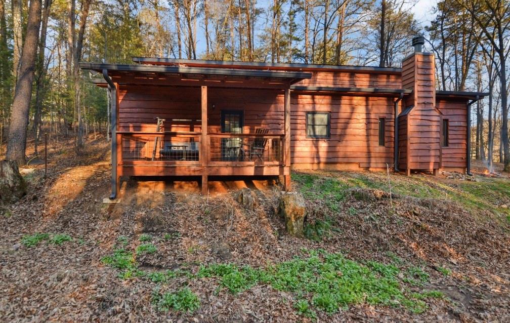 a view of a house with backyard and wooden fence